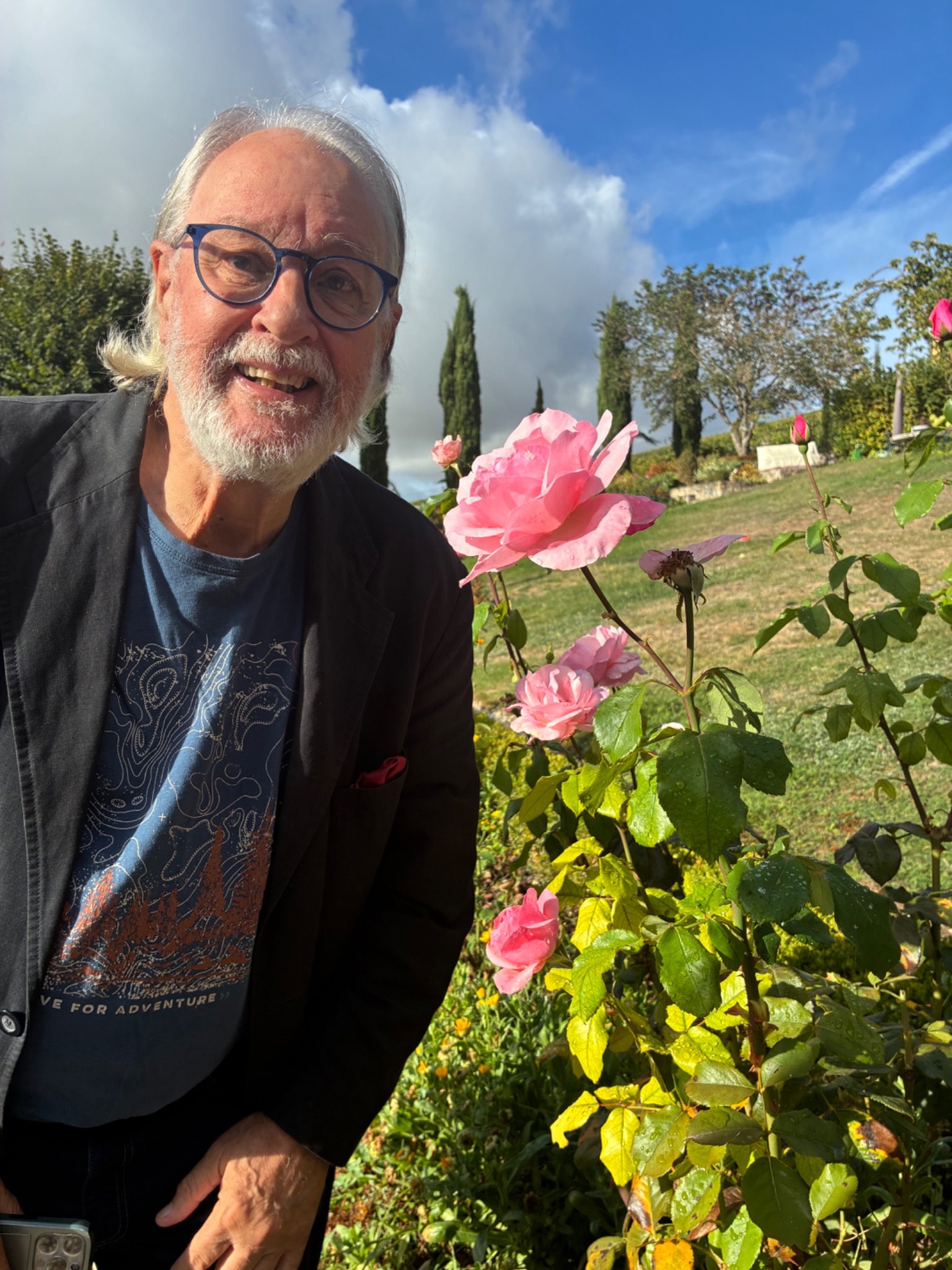 Rob in the garden beside the roses at Maison Renoux